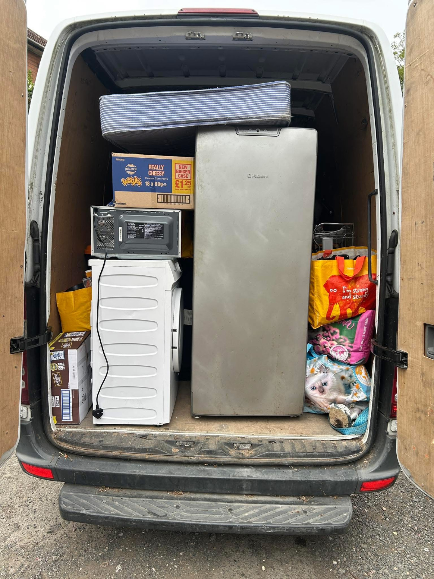 The Newys Removals van loaded with a fridge, washing machine and household items on a Birmingham clearance job