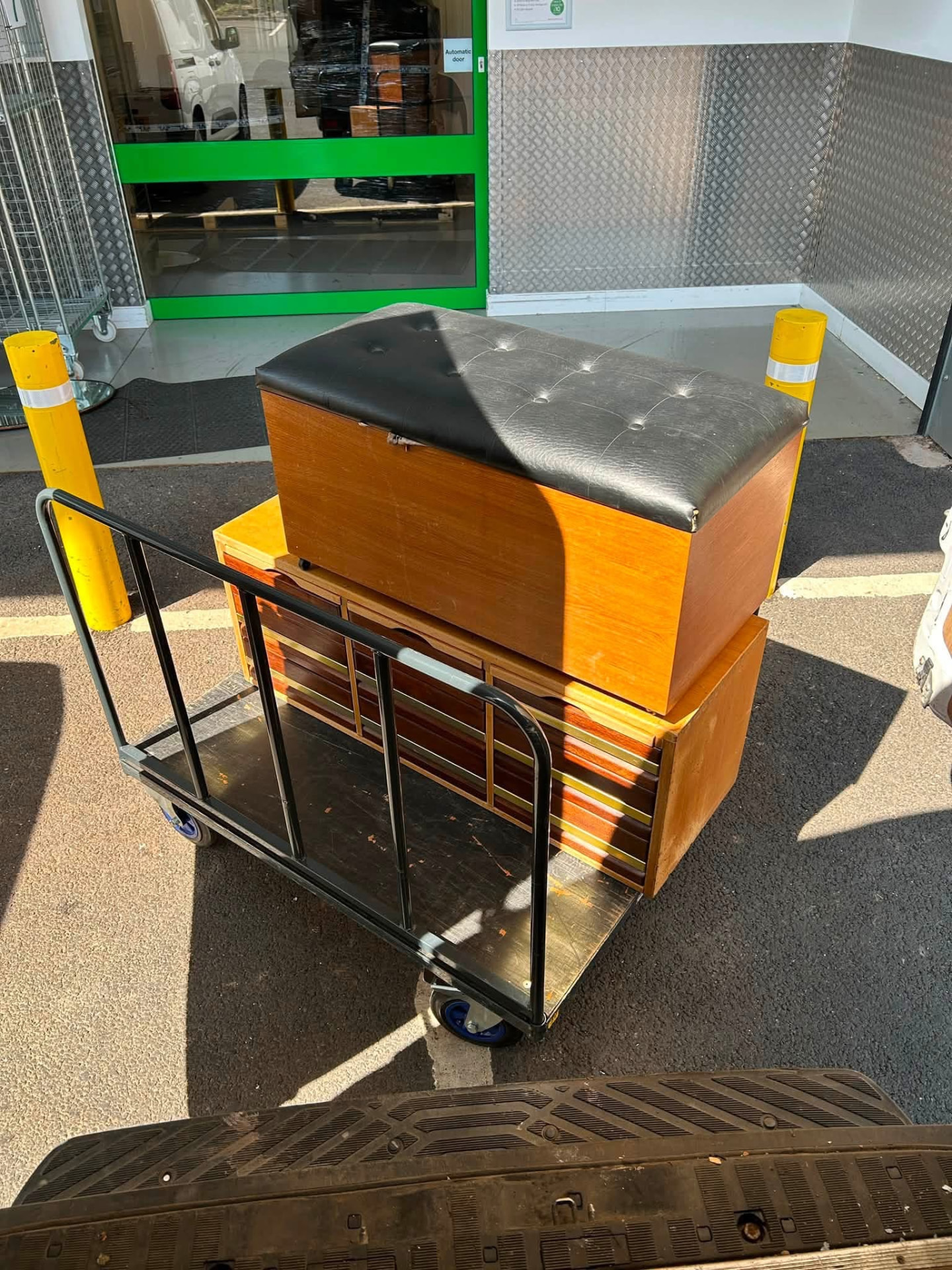 A storage ottoman and drawer units secured on a trolley during a house move in Birmingham